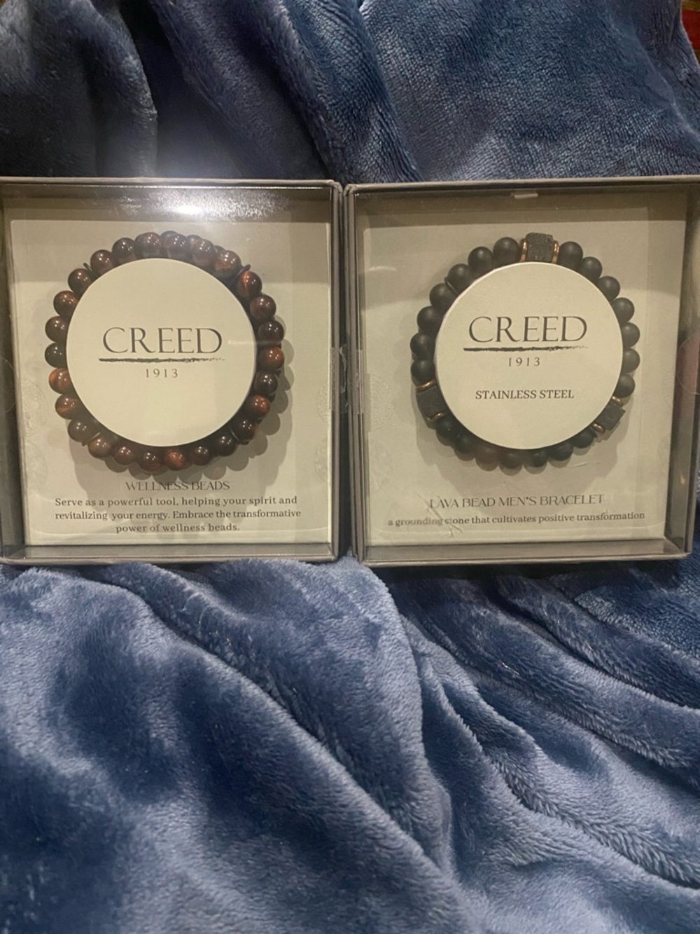 (2) Two Creed 1913 Beaded Bracelets one brown and One Black